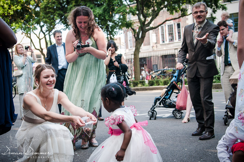 Bride collects coins tradition in front of the Stoke Newington Town Hall | London Wedding Photography